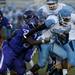 Pioneer senior defensive end Quashawn Luckett tackles Skyline senior running back Willie Elam on Friday. Daniel Brenner I AnnArbor.com